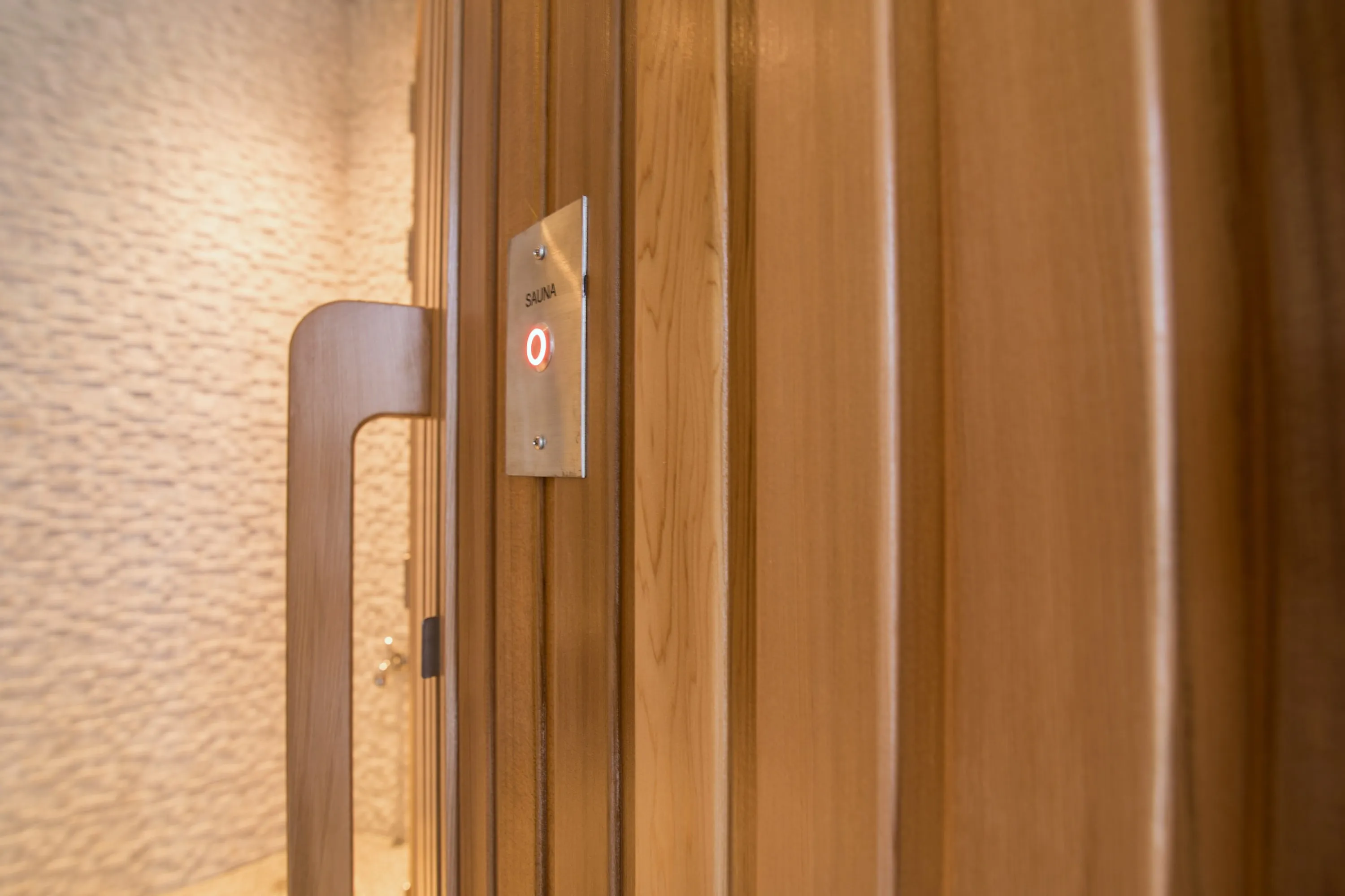 Timber door handle set into vertical cedar cladding