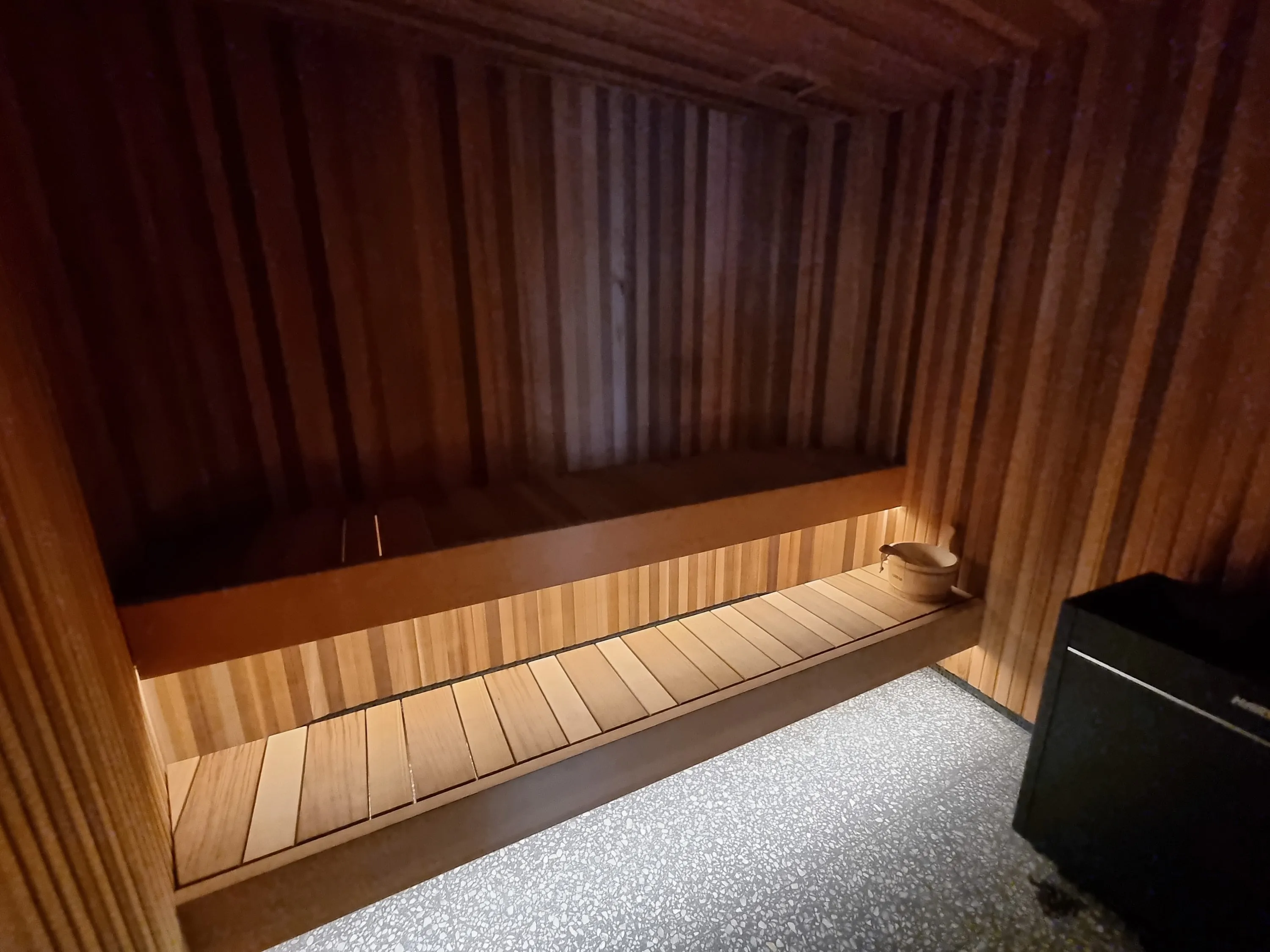 Long timber sauna bench with warm under-bench lighting