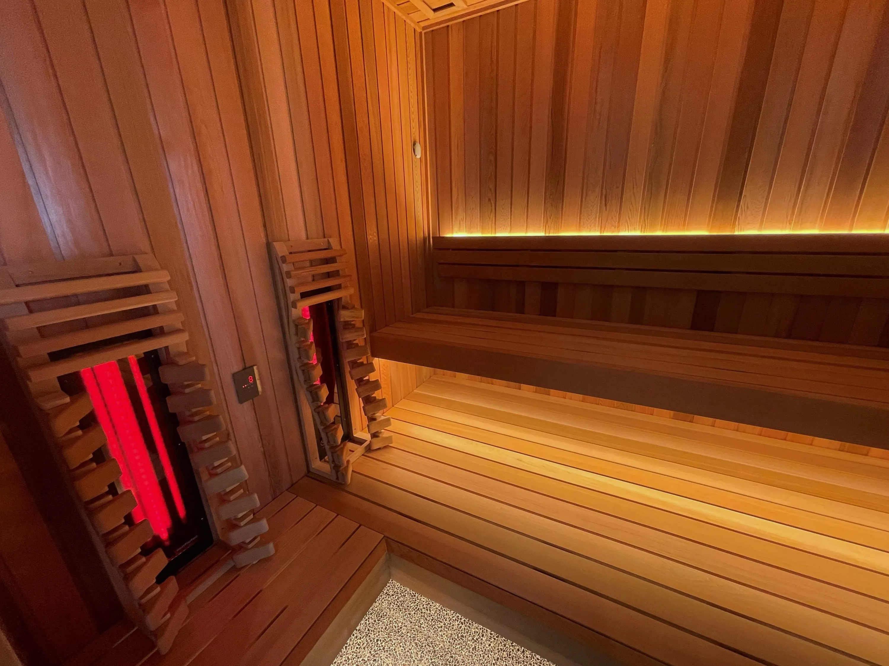 Timber hybrid sauna with infrared emitters behind slatted guards