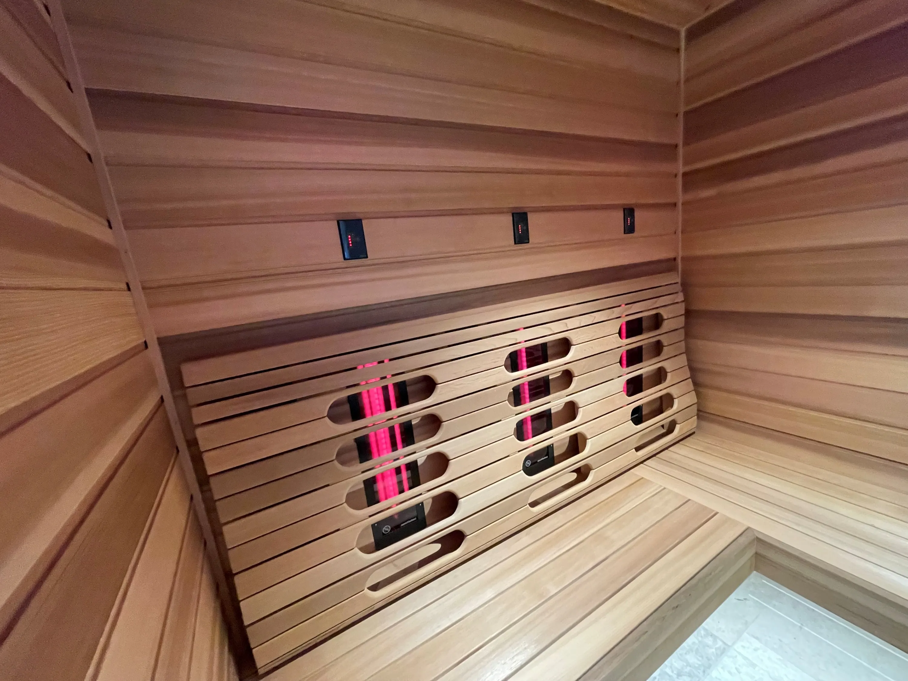 Angled timber backrest with integrated infrared emitters