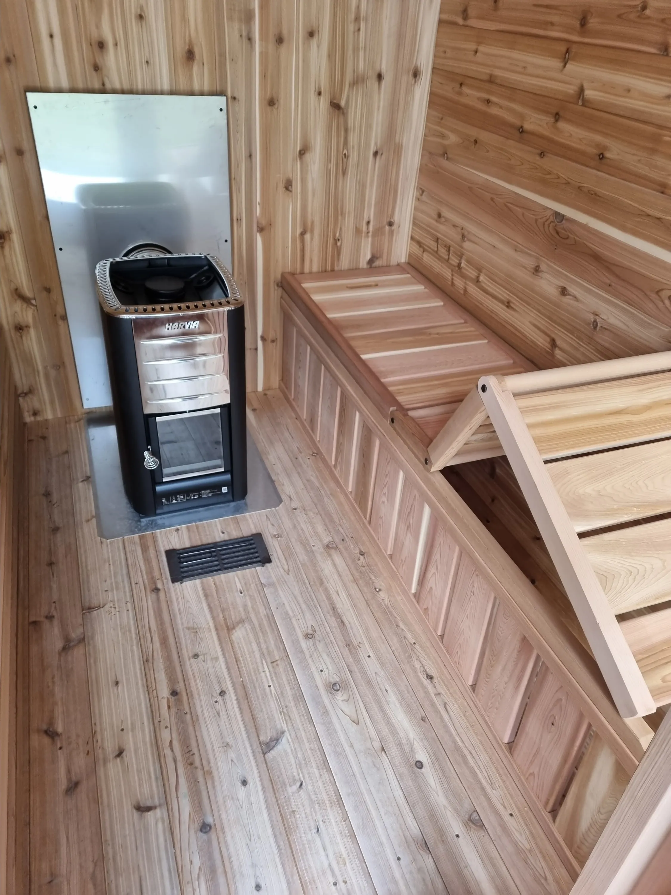 Cedar interior with benches running towards the wood-fired heater