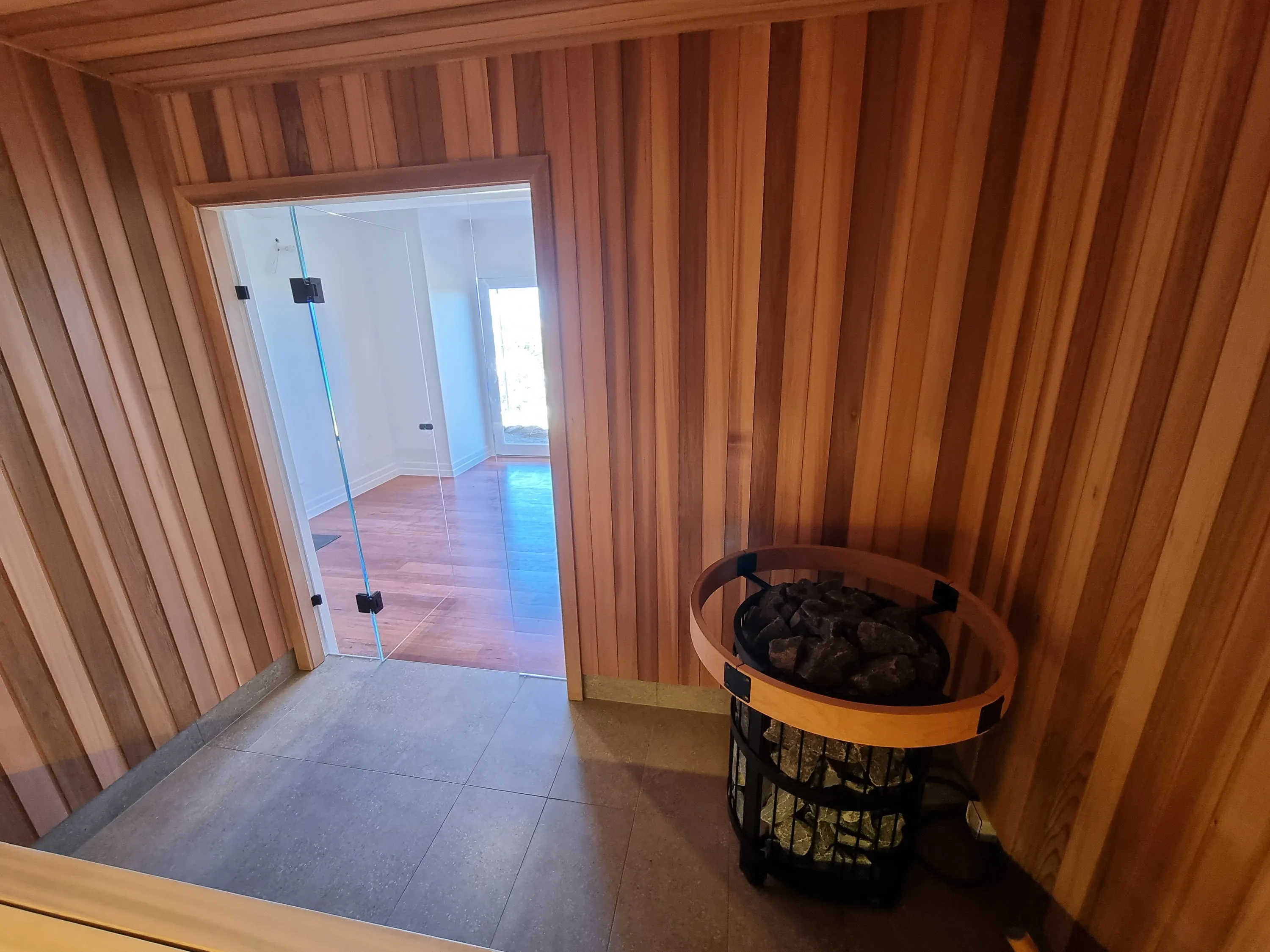View from inside the sauna through the open door to the house