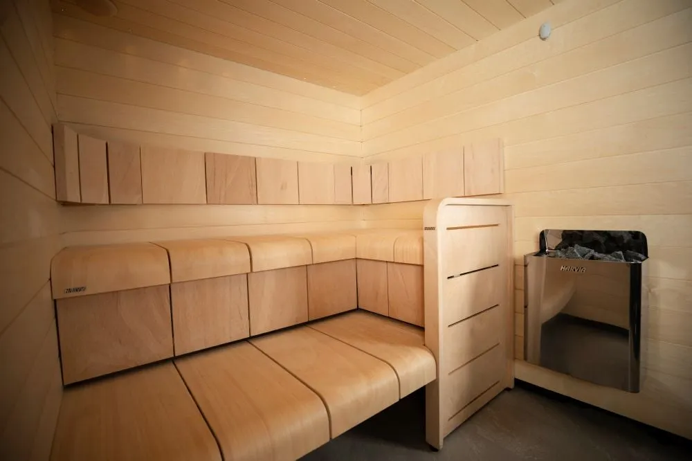 Harvia The Wall heater in a sauna with Harvia Ventura benches